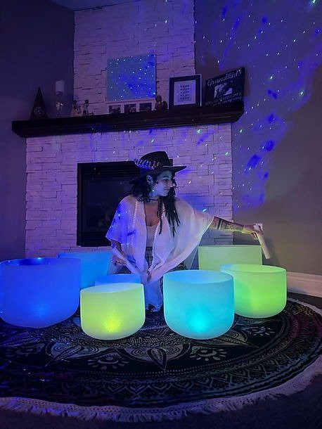Steph of Bohem Dreme playing crystal singing bowls during a sound journey
